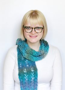 woman wearing a blue knitted scarf